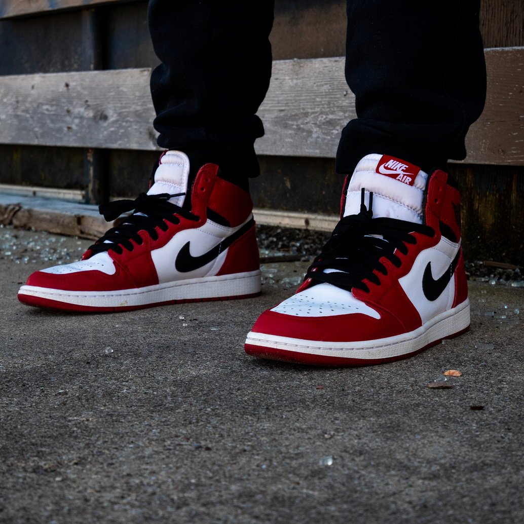 Man Wearing Nike Shoes Sitting on Wooden Bench